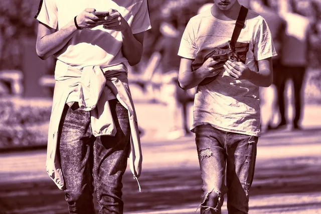 person, man, young man, guy, guys, two, two guys, friends, together, side by side, smartphone, walking, checking phone, outdoors, hand, holding phone, obsession, addicted, sunshine, sunny day, two guys, checking phone, holding phone, holding phone, holding phone, holding phone, obsession, obsession, obsession, obsession, obsession, addicted, addicted. Avoiding automated engagement that misrepresents personal attention