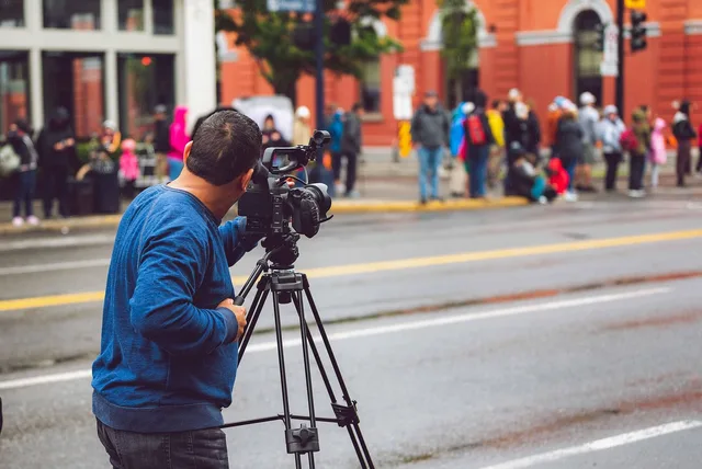 camera, man, person, street, video, negative space, empty, outdoors, city, alone, guy. Creating captions for a short LinkedIn expert video